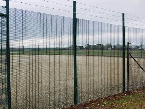 The 358 high security fence is installed in farmland with barbed wire.