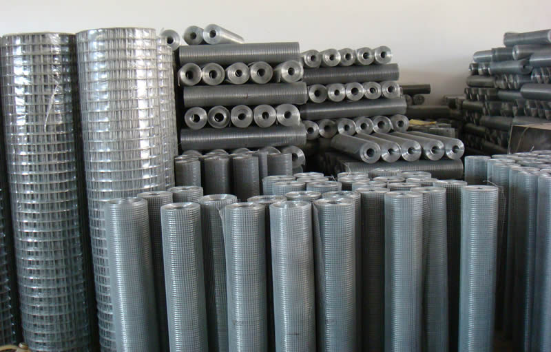 Many rolls of hot dipped galvanized welded wire mesh in workshop.
