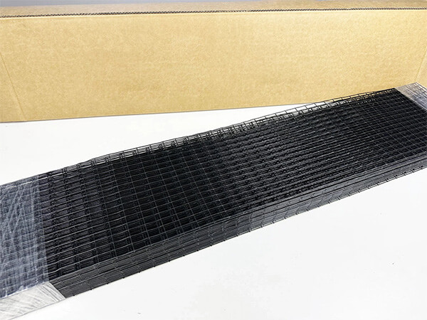Several pieces of pre-cut length solar panel meshes are placed beside the carton.