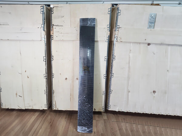 A bundle of pre-cut length solar panel meshes are leaning against the wooden case.