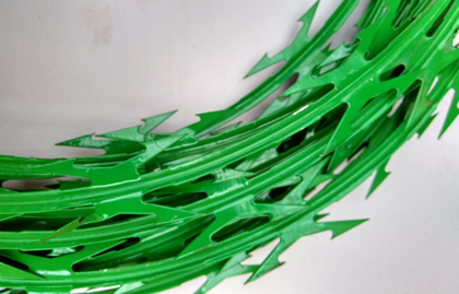 A corner of green PVC coated razor wire coil.