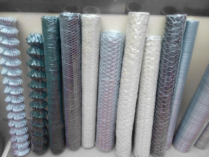 Many rolls of chain link fence, hexagonal wire netting, and welded mesh.