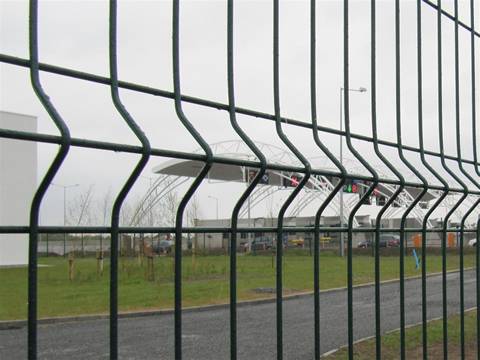Near the toll station, curvy fence panels are used as fence.