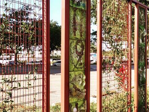 A set of display boards on street and several are made of ecological mesh with green climbers.