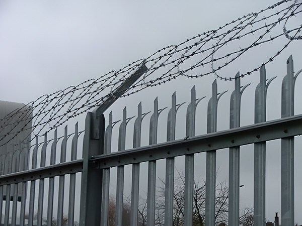 Palisade fencing with flat wrap razor wire installed at the top.