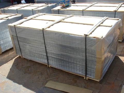 Many stacks of galvanized welded mesh panel is packed with plastic film and metal belt.
