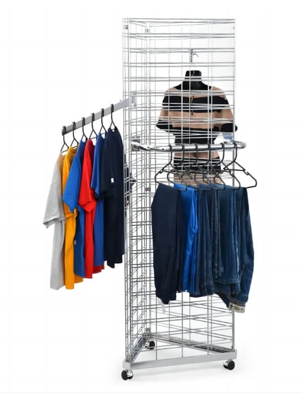 A triangle gridwall panel on the ground and several clothes hanging on it.