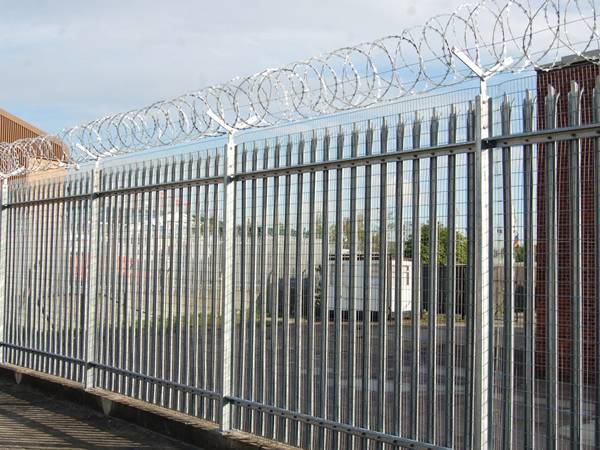 Concertina razor wires are installed at the top of palisade fences in the factory