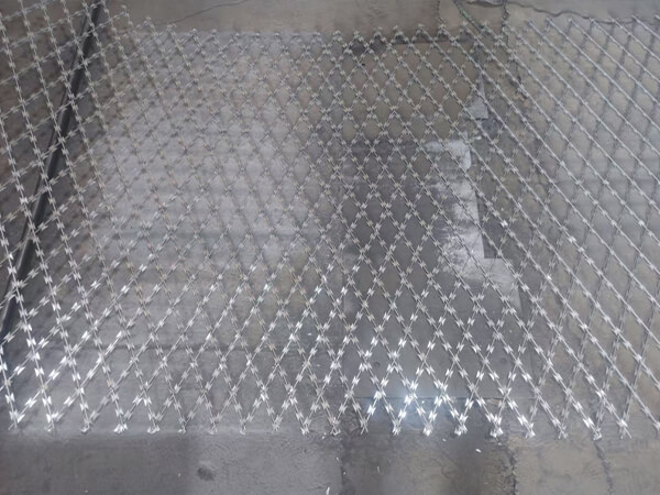 A piece of razor mesh fence mesh with diamond holes on the ground