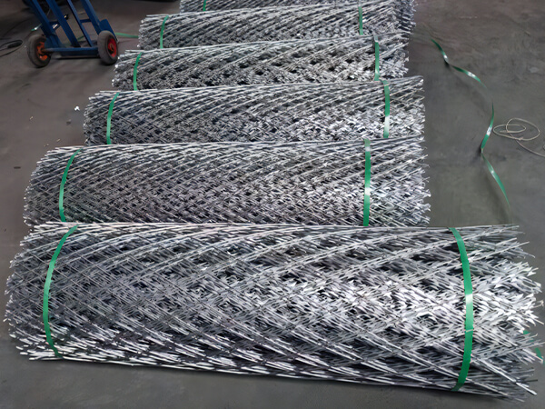 Several rolls of razor mesh fence on the ground