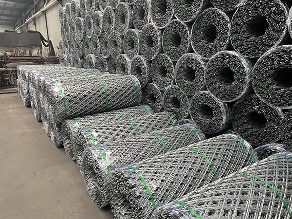 Several razor mesh fence rolls are neatly arranged in the factory