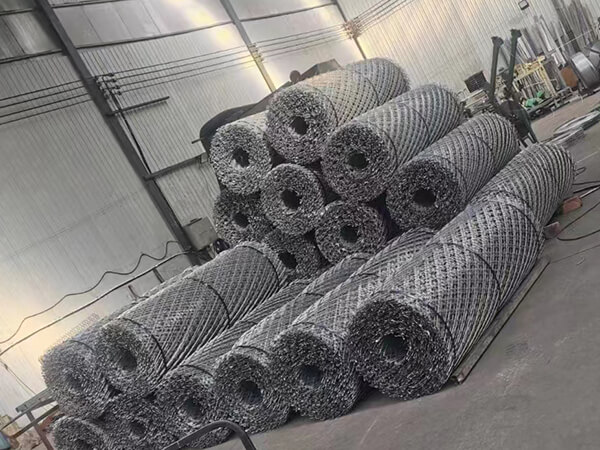Several razor mesh fence rolls are neatly arranged in the factory