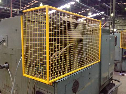 Safety machine guard is completely covered a machine with three hosts in a factory.