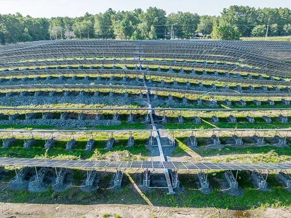 Gabion mesh secured with crushed stone for the base of solar panels on the slope of a landfill