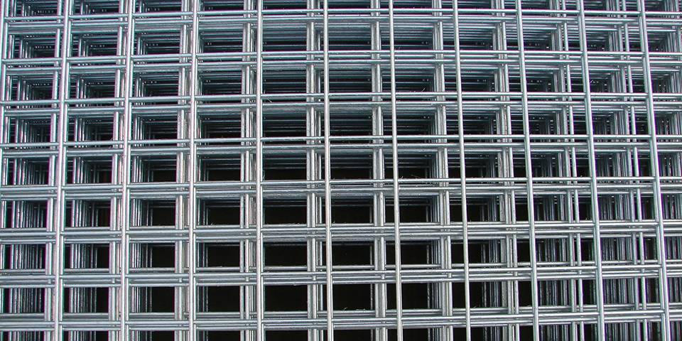 Many sheets of stainless steel welded mesh panel with rectangular holes.