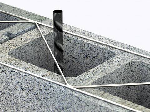 A piece of truss mesh reinforcement is in the brick of wall.