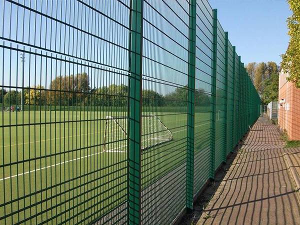 Raised fence on top of twin wire rebound fencing for soccer fields