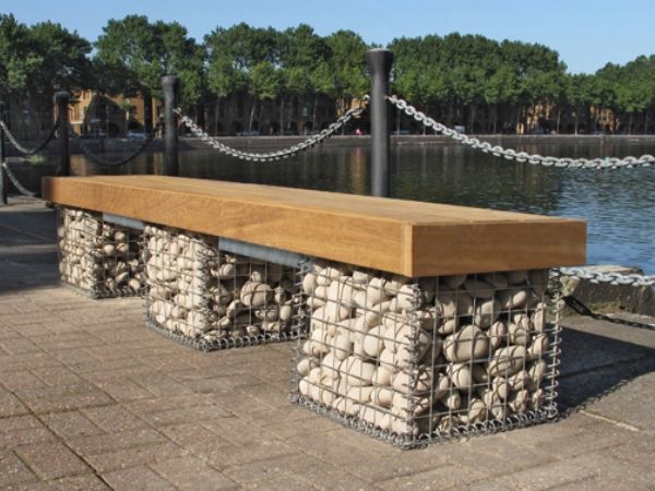 A welded gabion bench is placed at the riverside.