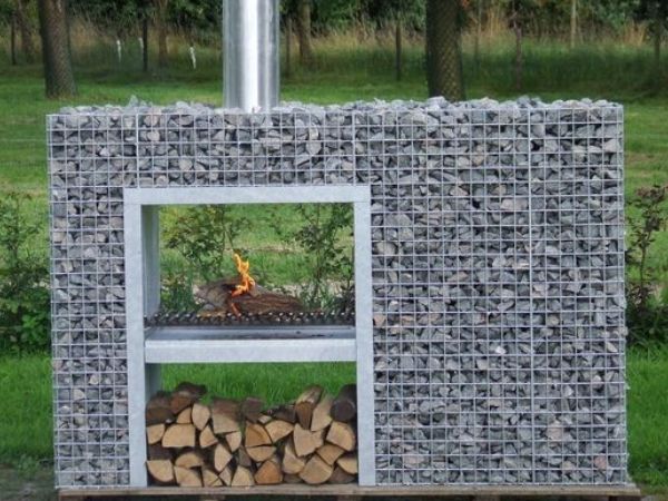 The fire is burning in the welded gabion fireplace.