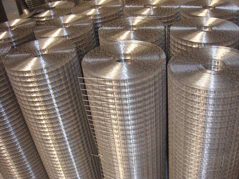 Several rolls of stainless steel welded wire mesh rolls on the ground.