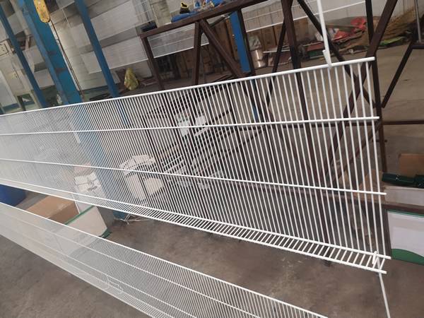 A surface treatment line of wire closet shelving.