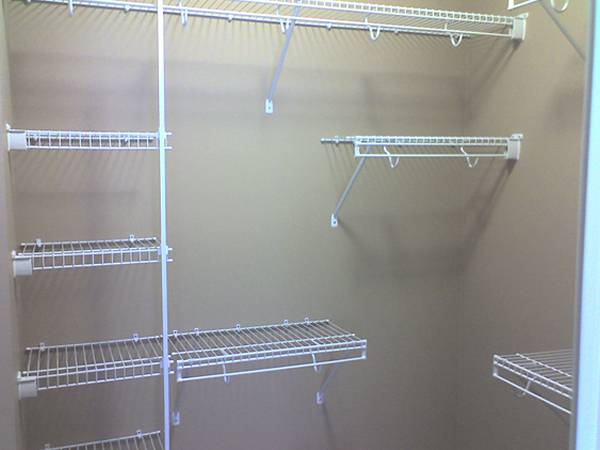 Several wire closet shelving in the closet.