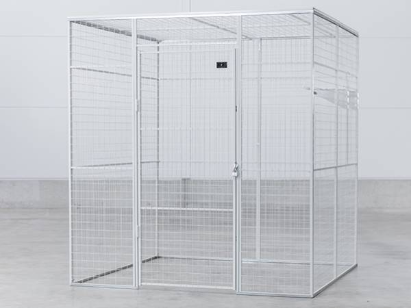 A galvanized mesh wire mesh storage locker on the ground.