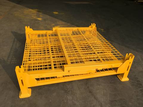A yellow painting welded wire container has been folded on the ground.